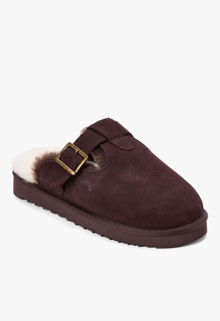 Dark brown suede mule slipper with cream shearling lining and an adjustable buckle strap.