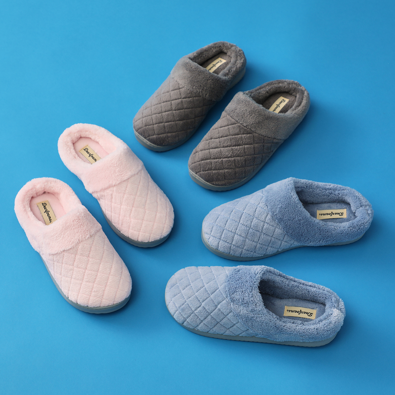 Quilted plush clog slippers in blush pink, charcoal gray, and light blue with soft faux fur collars.